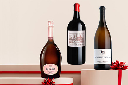 Three bottles of large format champagne, bordeaux wine and burgundy wine