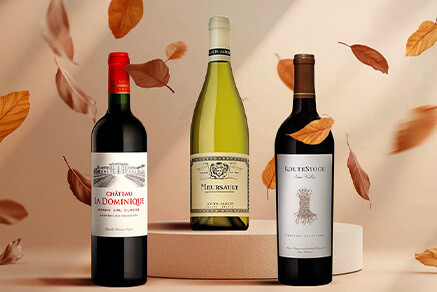 Three bottles of red wine with leafs