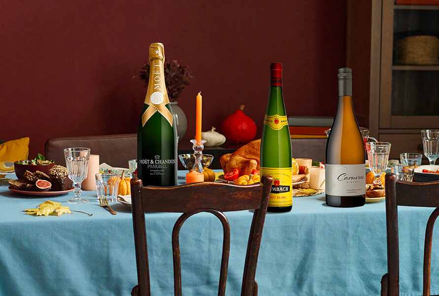 Three bottles of large format champagne, bordeaux wine and burgundy wine