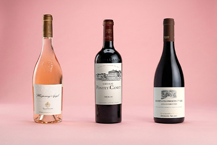 3 bottles on a pink background